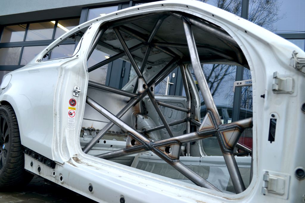 A safety cage or roll cage inside a white car.