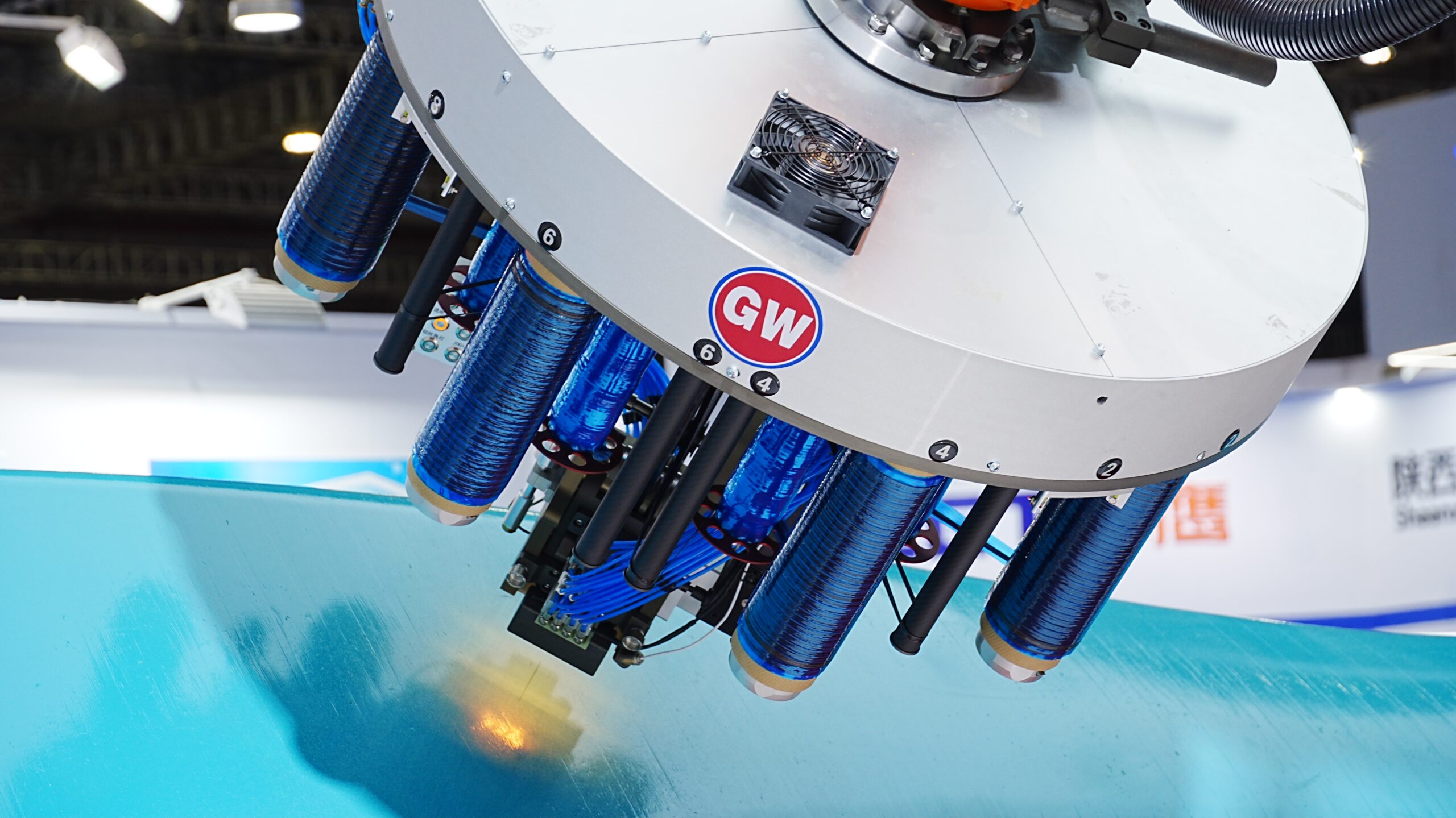 Automated Fiber Placement (AFP) head laying carbon fiber tows on a composite mold